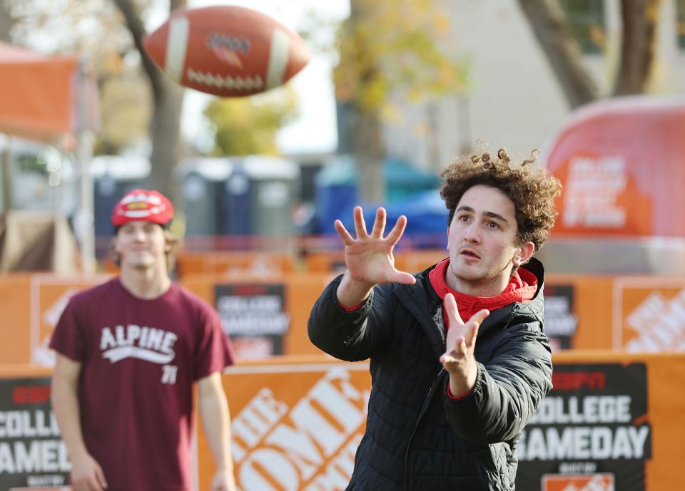 University of Utah student Sam Christensen plays catch as students camp out on Presidents Circle for the “College GameDay” broadcast in Salt Lake City on Friday, Oct. 27, 2023. | Jeffrey D. Allred, Deseret News