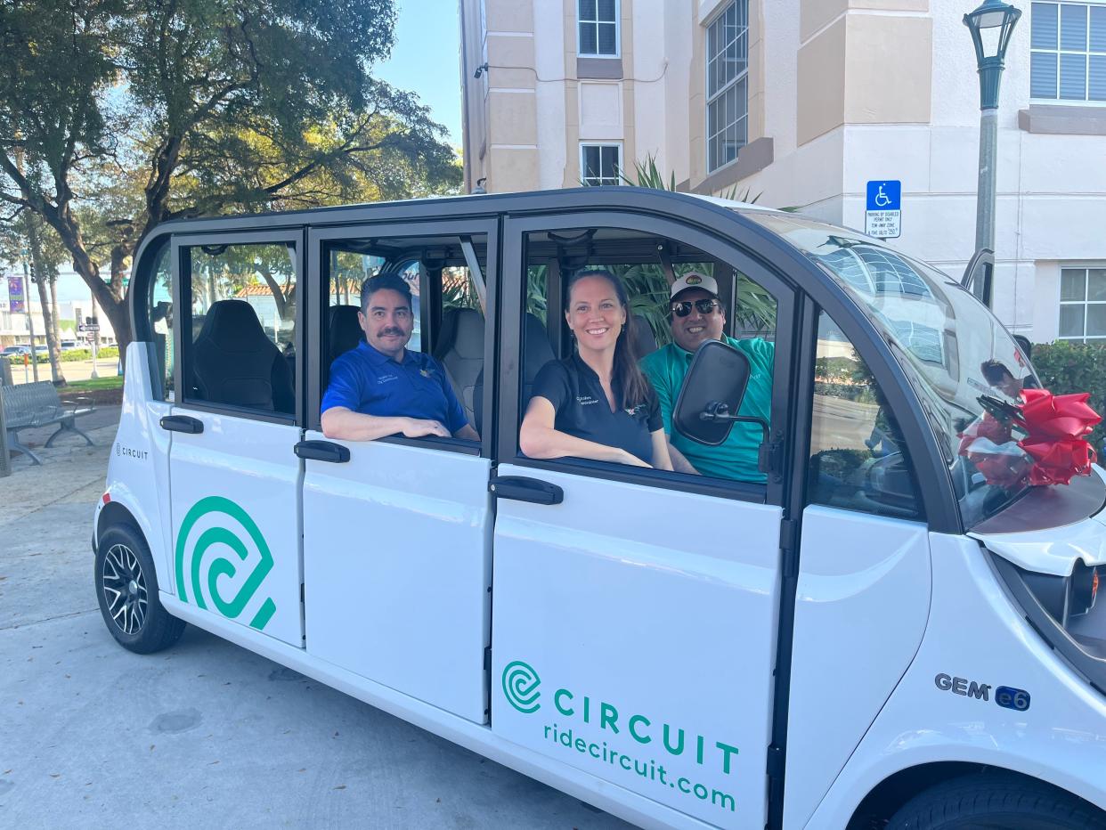 Electric vehicles are available in Lake Worth Beach and Boynton Beach to and from city locations. Seated in the six-passenger vehicle are Circuit Transit driver Dave Escobedo (right), Lake Worth Beach City Commissioners Kim Stokes and Reinaldo Diaz.