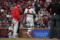 Philadelphia Phillies catcher J.T. Realmuto (10) walks off the field with manager Rob Thomson after being injured during the seventh inning of a baseball game against the St. Louis Cardinals Tuesday, April 9, 2024, in St. Louis. (AP Photo/Jeff Roberson)