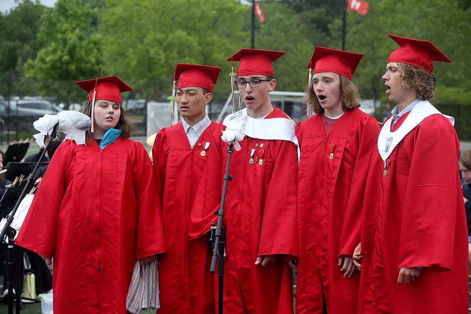 Hingham High senior chorus members sing the national anthem during commencement ceremonies for the Class of 2023 on Saturday, June 3, 2023. Hingham High graduated 318 seniors.