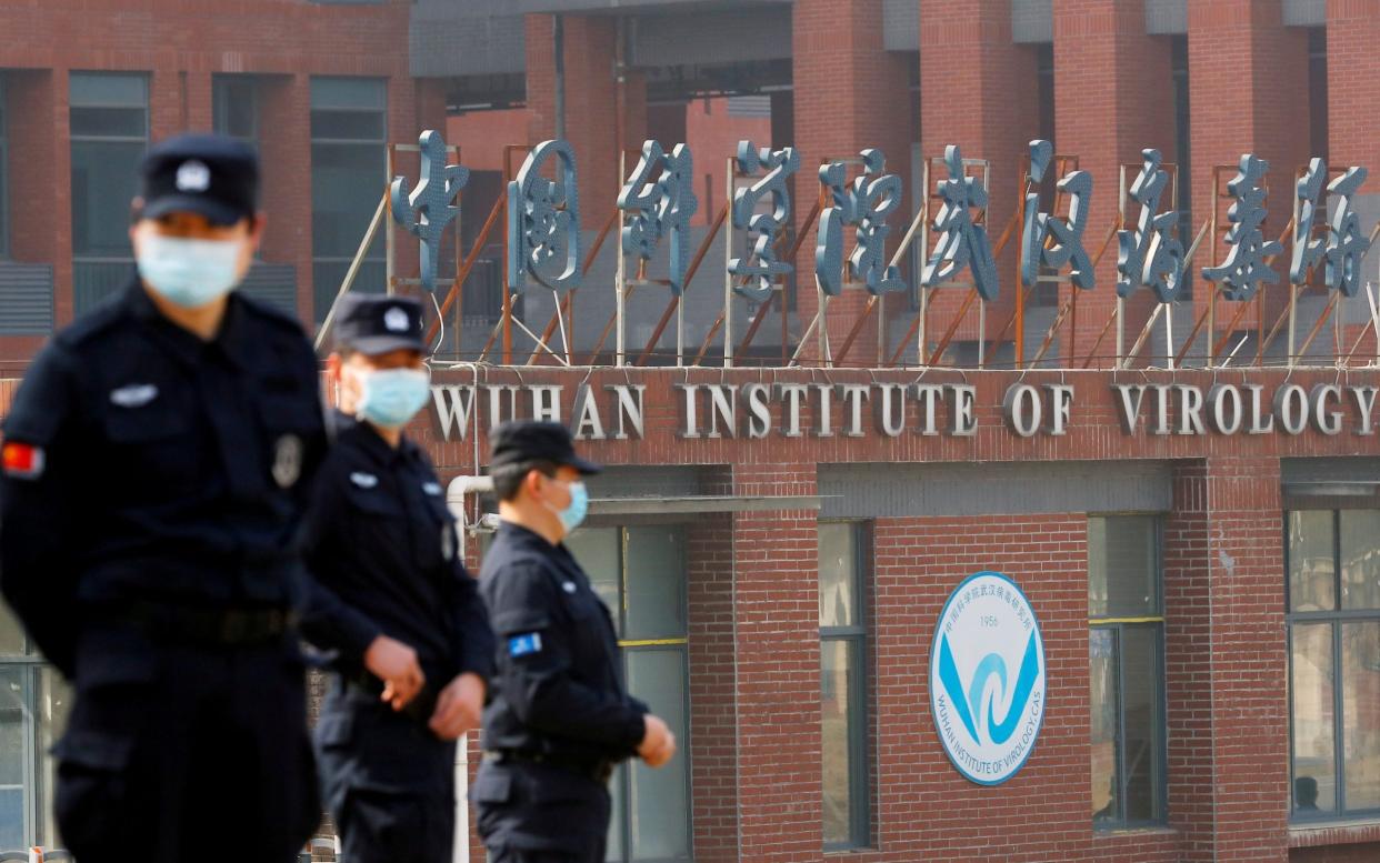 Security staff guard the Wuhan Institute of Virology  - Thomas Peter/ Reuters