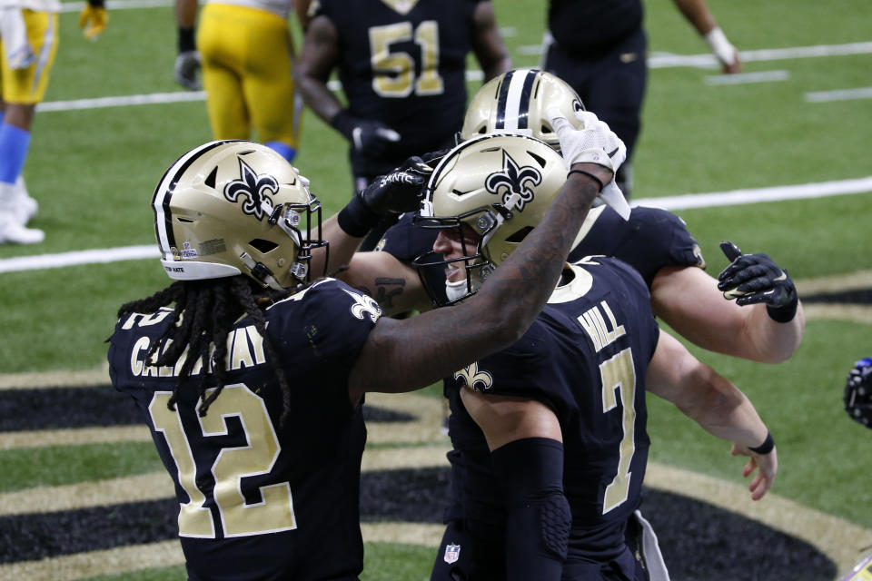 New Orleans Saints quarterback Taysom Hill (7) celebrates his touchdown with wide receiver Marquez Callaway (12) in the second half of an NFL football game against the Los Angeles Chargers in New Orleans, Monday, Oct. 12, 2020. (AP Photo/Butch Dill)