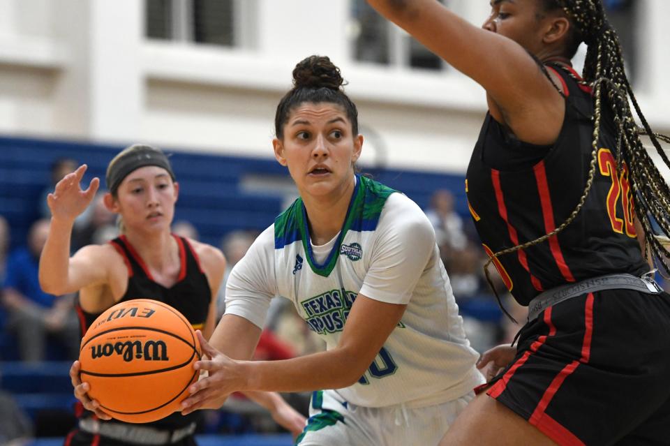 Texas A&M-Corpus Christi's Makinna Serrata, center, passes the ball against University of St. Thomas, Wednesday, Nov. 17, 2021, at Dugan Wellness Center.  The Islanders won, 79-38.