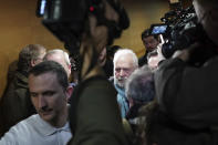 Former French priest Bernard Preynat, center, arrives at the Lyon court house, central France, Monday Jan.13, 2020. Bernard Preynat, is accused of sexually abusing some 75 Boy Scouts went on trial Monday _ but the proceedings were delayed until Tuesday because of a strike by lawyers. Preynat admitted in the 1990s to abusing boys, but was only removed from the priesthood last year. (AP Photo/Laurent Cipriani)