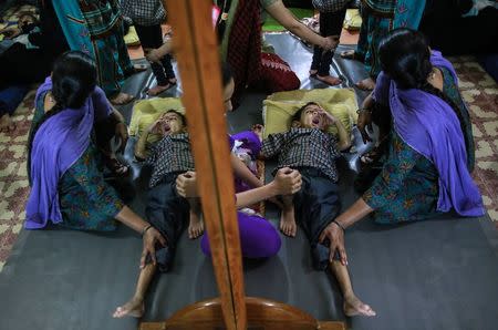 A boy receives treatment at a rehabilitation centre supported by Bhopal Medical Appeal for children who were born with mental and physical disabilities in Bhopal November 11, 2014. REUTERS/Danish Siddiqui