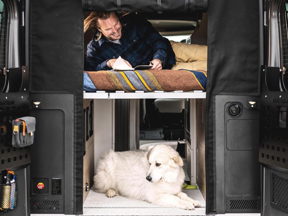 The Airstream's new Rangeline Touring Coach's with a person and a dog