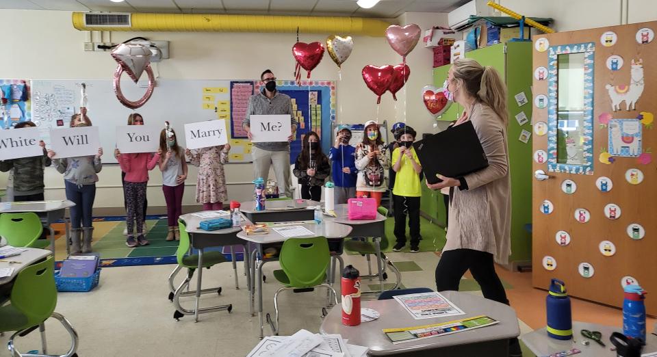 Dover third-grade teacher Nicole White is stunned to walk into a wedding proposal in her classroom at Garrison Elementary School Friday, Feb. 18, 2022.