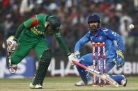 Bangladesh's captain Mushfiqur Rahim runs to avoid a run out as India's wicketkeeper Dinesh Karthik (R) breaks the wicket to dismiss him unsuccessfully during their Asia Cup 2014 one-day international (ODI) cricket match in Fatullah February 26, 2014.