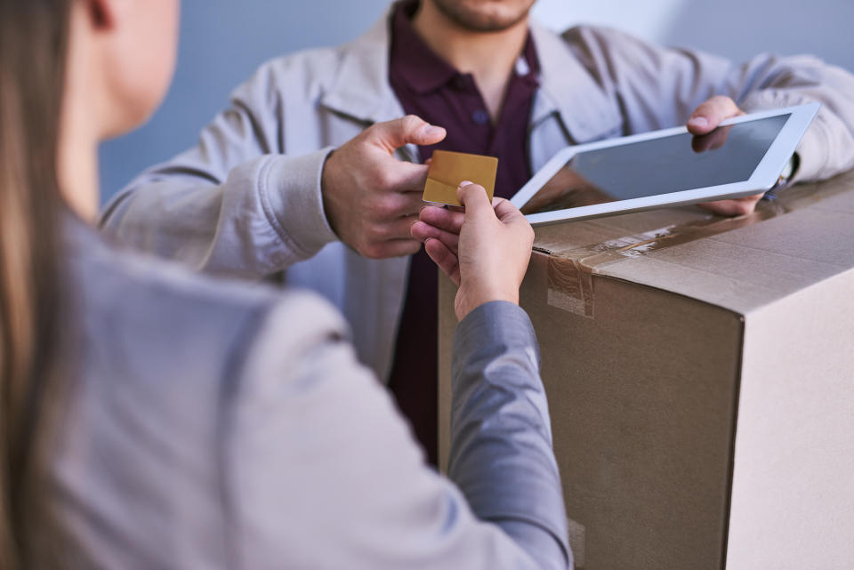 Cropped shot of a courier accepting a credit card payment for a delivery