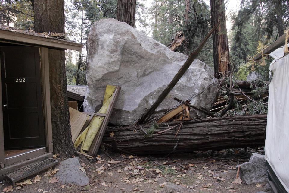 FILE - In this Monday, Oct. 20, 2008 file photo, a boulder sits atop debris after it fell in Curry Village in Yosemite National Park, Calif. Falling boulders are the single biggest force shaping Yosemite Valley, one of the most popular tourist destinations in the national park system. Now swaths of some popular haunts are closing for good after geologists confirmed that unsuspecting tourists and employees are being lodged in harm's way. On Thursday, June 13, 2012, the National Park Service will announce that potential danger from the unstable 3,000-foot-tall Glacier Point, a granite promontory that for decades has provided a dramatic backdrop to park events, will leave some of the valley's most popular lodging areas permanently uninhabitable. (AP Photo/Paul Sakuma, File)