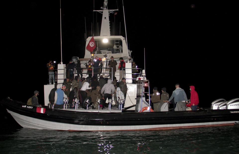 Migrants, mainly from sub-Saharan Africa, are stopped by Tunisian Maritime National Guard at sea during an attempt to get to Italy, near the coast of Sfax, Tunisia, Tuesday, April 18, 2023. The Associated Press, on a recent overnight expedition with the National Guard, witnessed migrants pleading to continue their journeys to Italy in unseaworthy vessels, some taking on water. Over 14 hours, 372 people were plucked from their fragile boats. (AP Photo)