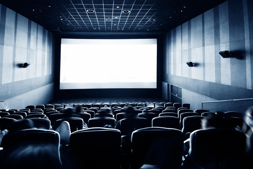 Rear view of people at the cinema (Credit: Getty)