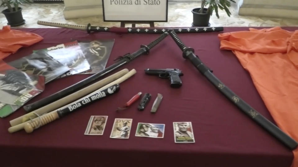 This picture taken from a publicly distributed police video shows some of the items recovered in the homes of 24 people investigated for apology of Fascism in Ferrara, northern Italy, Wednesday, Feb. 14, 2024. Italian police on Wednesday raided the homes of 24 people under investigation for apology of fascism inciting racial hatred during a gathering at a restaurant in the Jewish quarter of Ferrara during which they lauded dictators Benito Mussolini and Adolf Hitler. (Italian Police via AP)