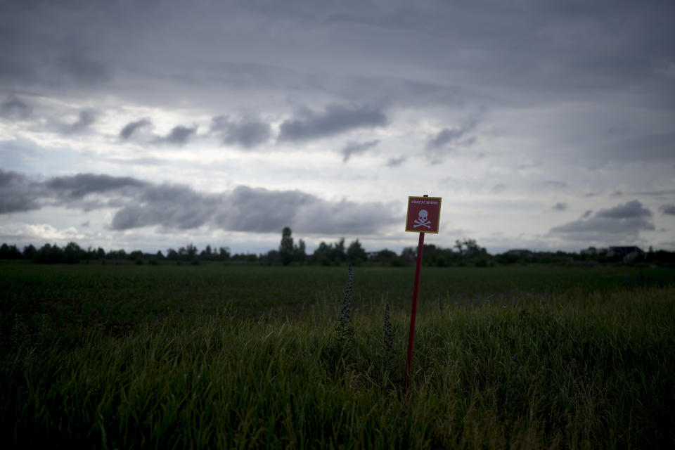 A poster warning about mines in Makariv, on the outskirts of Kyiv, Ukraine, Tuesday, June 14, 2022. Russia’s invasion of Ukraine is spreading a deadly litter of mines, bombs and other explosive devices that will endanger civilian lives and limbs long after the fighting stops. (AP Photo/Natacha Pisarenko)