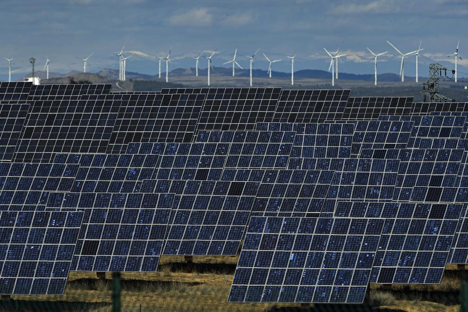 Solar panels work near the small town of Milagro, Navarra Province, northern Spain, Friday, Feb. 24, 2023. Spain is building on its reputation in renewable energy to position itself as Europe's future leader in green hydrogen. But some energy sector experts express caution over ramping up an industry that would be wholly reliant on massive increases in the availability of zero-carbon electricity made from sources like wind or solar. (AP Photo/Alvaro Barrientos)