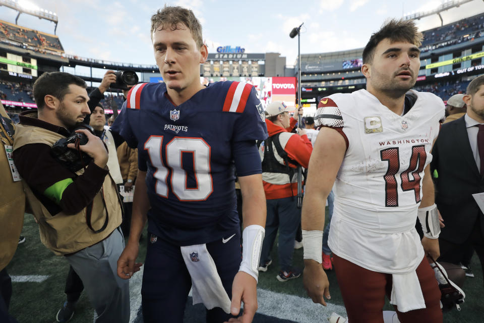 New England Patriots quarterback Mac Jones (10) and Washington Commanders quarterback Sam Howell (14) step off the field after greeting one another following an NFL football game, Sunday, Nov. 5, 2023, in Foxborough, Mass. (AP Photo/Michael Dwyer)