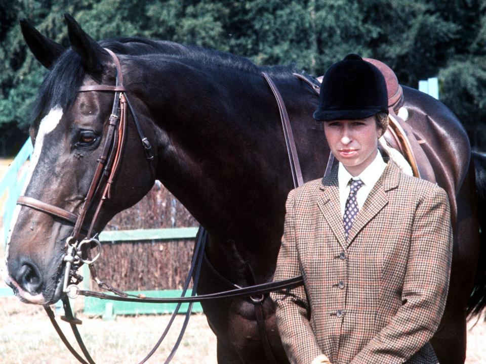 Princess Anne stands next to her horse at the Olympics.