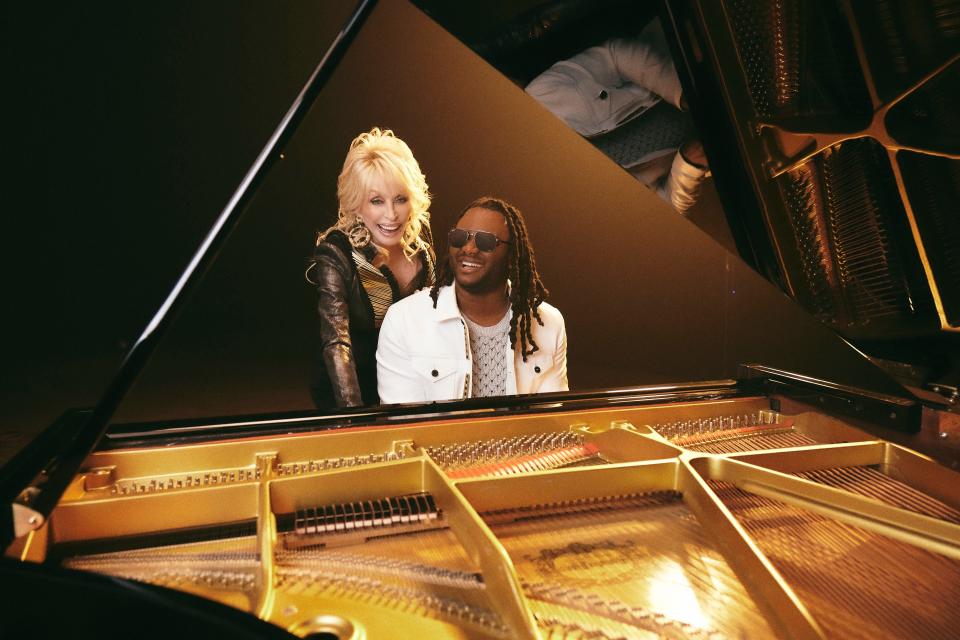 Christian singer and songwriter Blessing Offor poses with Dolly Parton on the set of the video for their new duet "Somebody's Child."