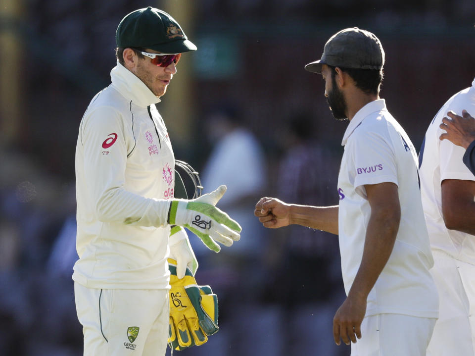 Rival captain's Australia's Tim Paine, left, and India's Ajinkya Rahane gesture to each other following play on the final day of the third cricket test between India and Australia at the Sydney Cricket Ground, Sydney, Australia, Monday, Jan. 11, 2021. The test ended in a draw and the series is at 1-1 all with one test to play. (AP Photo/Rick Rycroft)