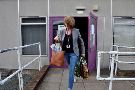 A former employee leaves the Monarch Training Centre, after the airline ceased trading, at Luton airport, Britain October 2, 2017. REUTERS/Mary Turner