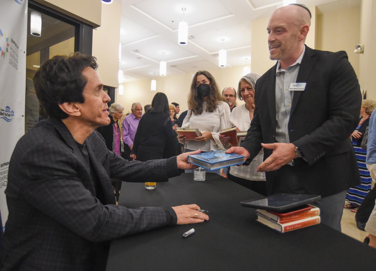 Best-selling author Mitch Albom (left) talks with Mike Jarvis, of Stuart, after signing several of his books for Jarvis at Temple Beit HaYam after the Rappaport Center Speaker Series on Wednesday, Jan. 24, 2024, in Stuart. "It was an incredible experience, Mitch is an incredibly engaging speaker," Jarvis said.