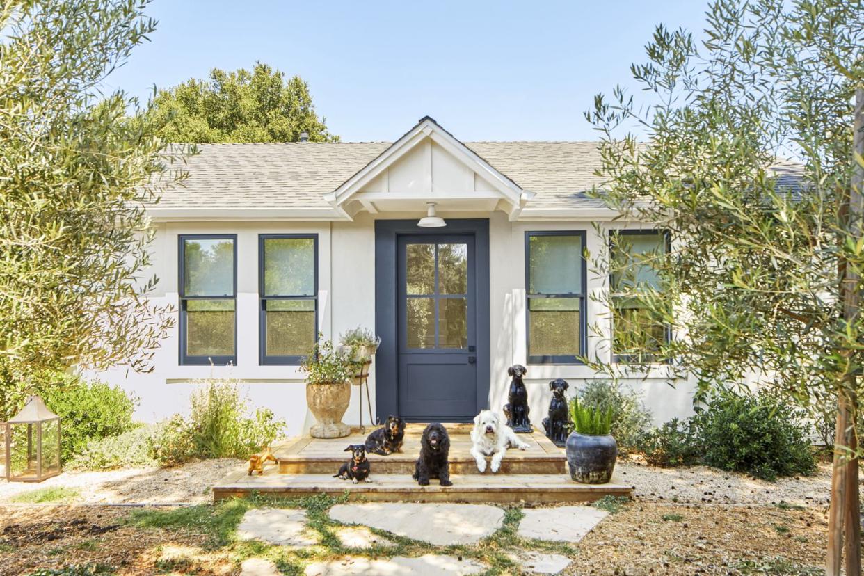 small white house with deep blue door and window trim