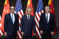 Chinese Vice Premier Liu He, center, poses with U.S. Trade Representative Robert Lighthizer, right, and Treasury Secretary Steven Mnuchin, for photos before holding talks at the Xijiao Conference Center in Shanghai Wednesday, July 31, 2019. (AP Photo/Ng Han Guan, Pool)