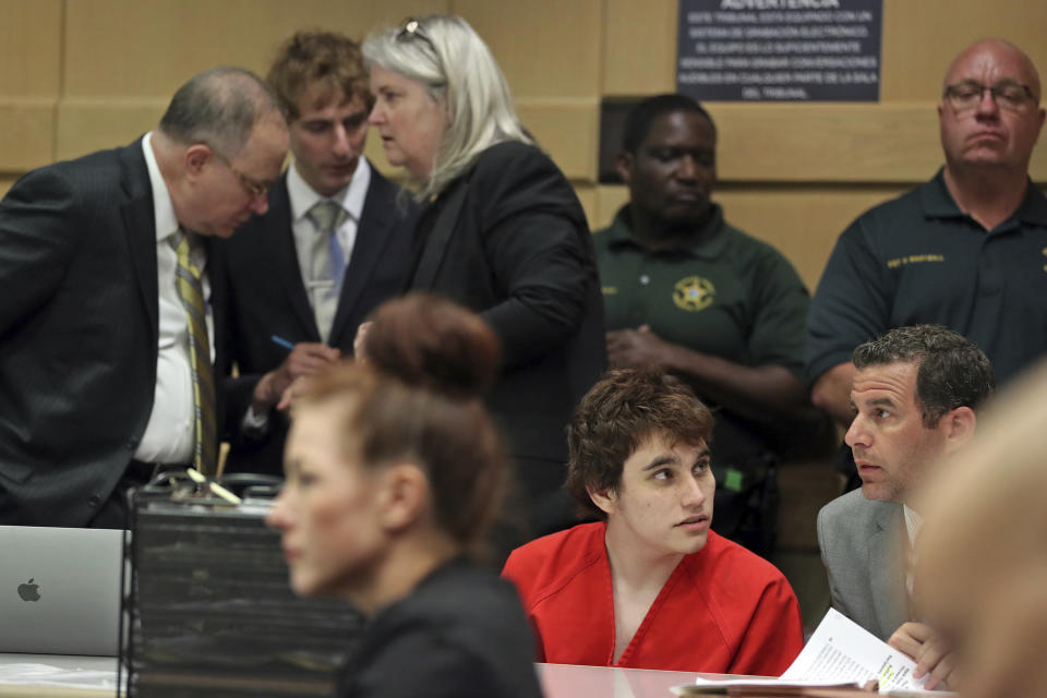 School shooting suspect Nikolas Cruz, center, speaks with attorney Gabe Ermine as members of his defense team, from left; David Frankel, Joseph Burke and Diane Cuddihy, confer behind him before a hearing at the Broward Courthouse in Fort Lauderdale, Fla., Tuesday, May 28, 2019. (Amy Beth Bennett/South Florida Sun Sentinel via AP, Pool)