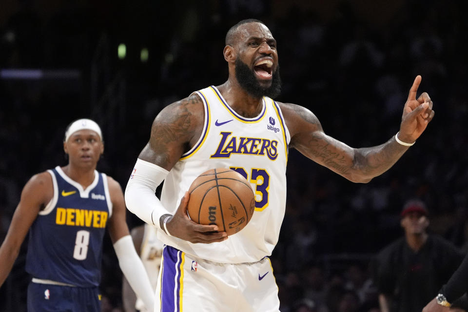 Los Angeles Lakers forward LeBron James, right, questions an out of bounds call as Denver Nuggets forward Peyton Watson looks on during the first half in Game 4 of an NBA basketball first-round playoff series Saturday, April 27, 2024, in Los Angeles. (AP Photo/Mark J. Terrill)