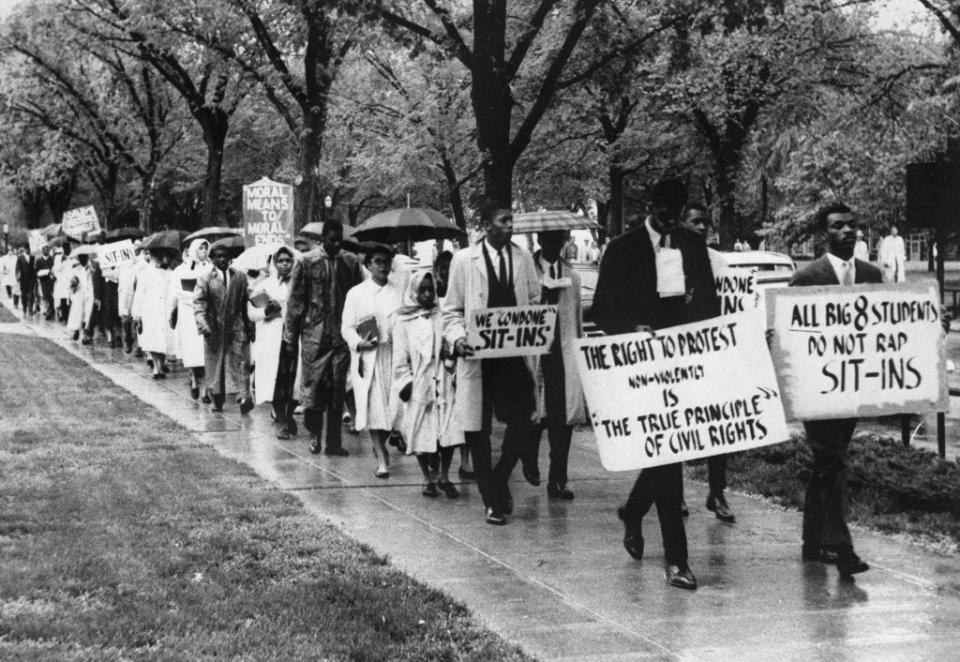 Black students marched through the Kansas University campus holding signs protesting a resolution against civil rights sit-ins