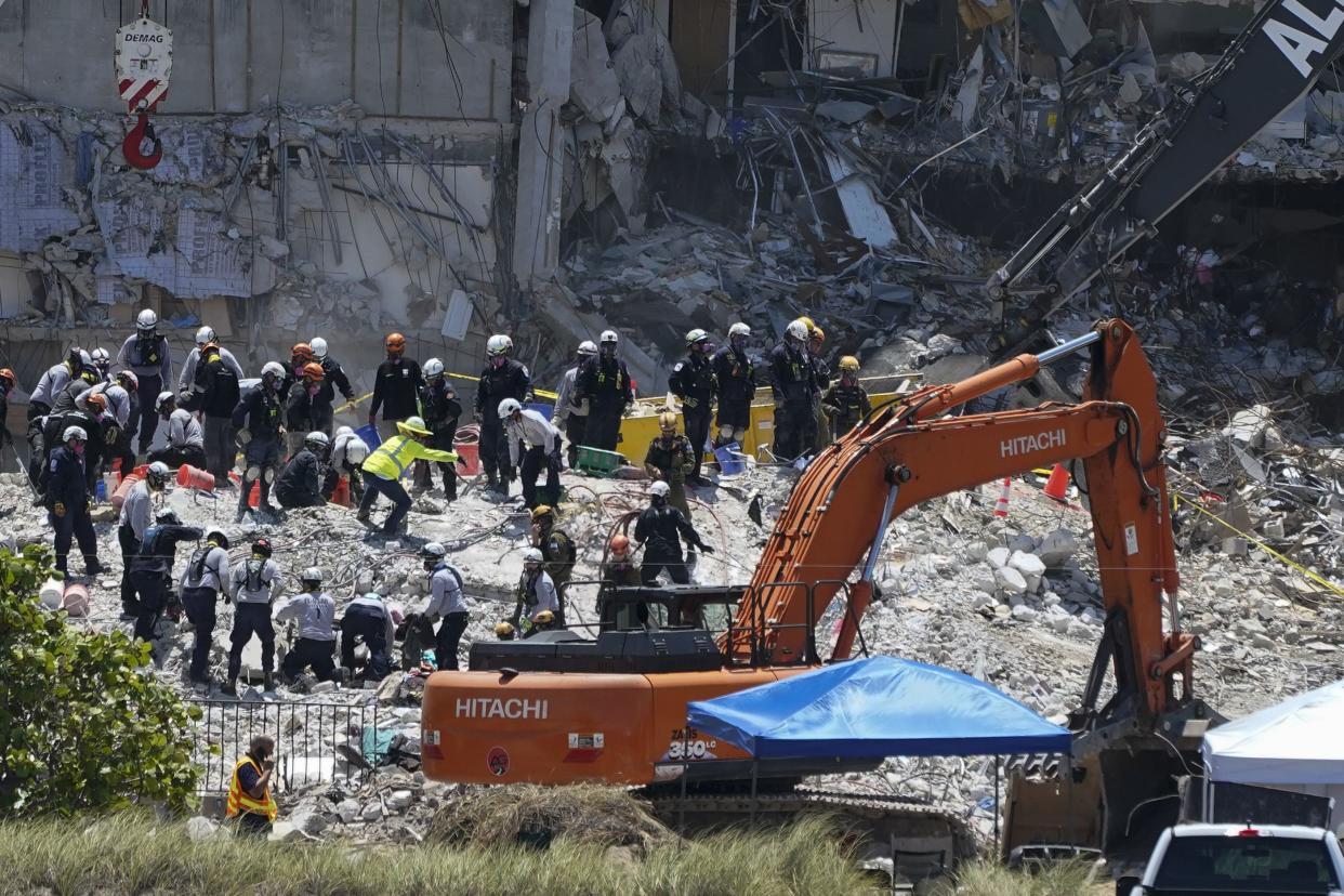 Search and rescue personnel work atop the rubble at the Champlain Towers South condo building, where scores of victims remain missing more than a week after it partially collapsed, on Friday, July 2, 2021, in Surfside, Fla.