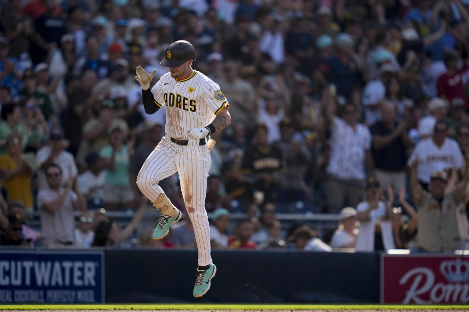 San Diego Padres' Jackson Merrill, right, celebrates after hitting a three-run home run during the fourth inning of a baseball game against the Milwaukee Brewers, Saturday, June 22, 2024, in San Diego. (AP Photo/Gregory Bull)