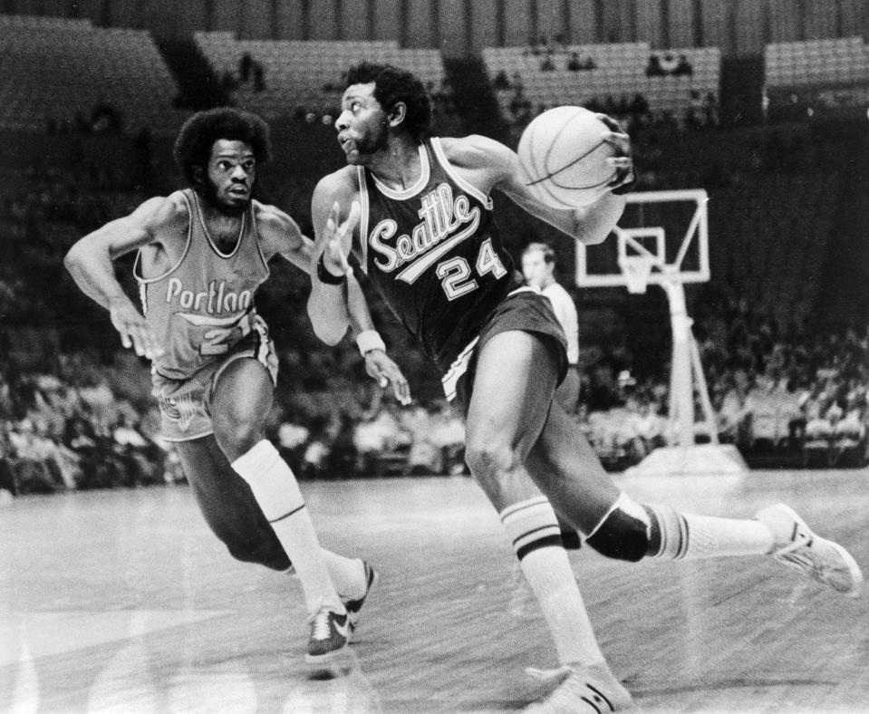 FILE - Spencer Haywood (24) of the Seattle SuperSonics drives around Sidney Wicks of the Portland Trail Blazers as he drives toward the basket during their NBA exhibition game at the Forum in Los Angeles, Calif., Oct. 7, 1972. With rare exceptions, the best high school basketball players for decades went on to play in college. Then came Spencer Haywood, whose fight with the NBA set the stage for the one-and-done era in college hoops. (AP Photo/Harold Filan, File)