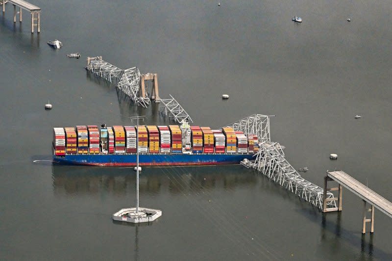 A damaged container ship rests next to a bridge pillar in the Patapsco River after crashing into and destroying the Francis Scott Key Bridge at the entrance to Baltimore harbor in Maryland. Six construction workers are presumed dead, after the Coast Guard called off its search. Photo by David Tulis/UPI