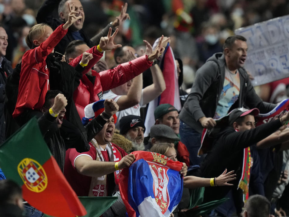 Serbian fans celebrate at the end of the World Cup 2022 group A qualifying soccer match between Portugal and Serbia at the Luz stadium in Lisbon, Sunday, Nov 14, 2021. (AP Photo/Armando Franca)