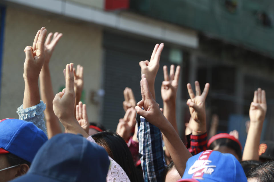 Protesters flash the three-fingered salute during a rally in Yangon, Myanmar, on Feb. 6, 2021. Protests in Myanmar against the military coup that removed Aung San Suu Kyi’s government from power have grown in recent days despite official efforts to make organizing them difficult or even illegal. (AP Photo)