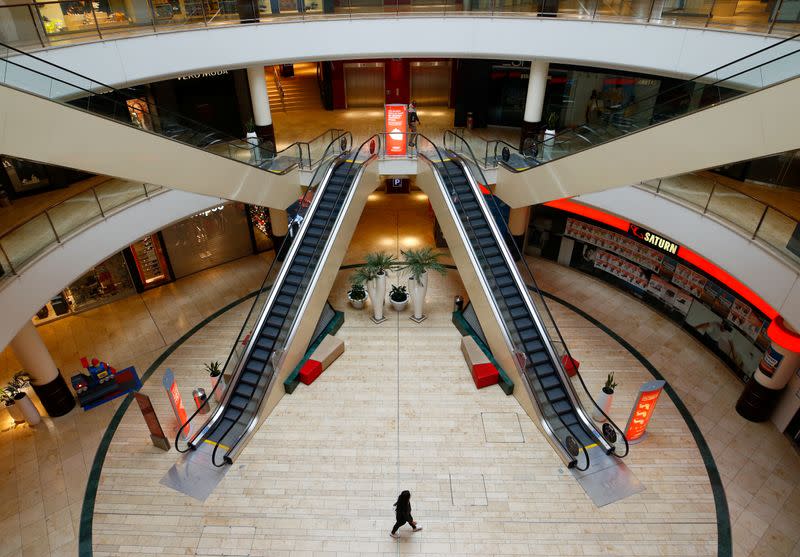 FILE PHOTO: A person is seen inside an empty shopping mall during a partial lockdown in Leverkusen