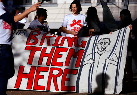 Refugee advocates hold a banner during a protest in central Sydney, Australia, October 5, 2016 calling for the closure of the Australian detention centres in Nauru and Manus Island. REUTERS/David Gray/File Photo