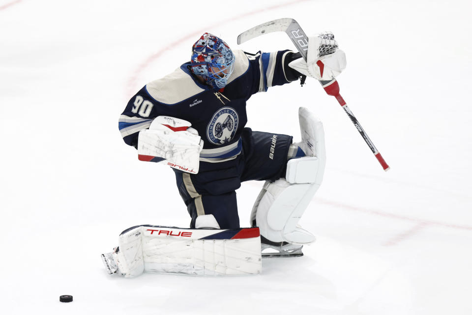 Columbus Blue Jackets goalie Elvis Merzlikins celebrates his stop against Pittsburgh Penguins forward Evgeni Malkin in a shootout to win an NHL hockey game in Columbus, Ohio, Saturday, March 30, 2024. The Blue Jackets won 4-3 in a shootout. (AP Photo/Paul Vernon)