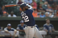 FILE - In this June 26, 2019, file photo, San Diego Padres' Franmil Reyes follows through on a two run home run against the Baltimore Orioles in the fifth inning of a baseball game, in Baltimore. The Indians bulked up for the playoff race by trading temperamental starter Trevor Bauer before the deadline to Cincinnati in a three-team deal they hope can help them run down the Minnesota Twins. Cleveland, which trails the AL Central by three games but leads the wild-card race, sent Bauer to the Reds for slugger Yasiel Puig and left-hander Scott Moss. The Indians also acquired outfielder Franmil Reyes, lefty Logan Allen and infield prospect Victor Nova from the San Diego Padres, who acquired outfielder Taylor Trammel from the Reds.(AP Photo/Gail Burton, File)