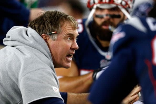 FOXBORO, MA - JANUARY 13:  Head coach Bill Belichick of the New England Patriots talks with his team during the 2013 AFC Divisional Playoffs game against the Houston Texans at Gillette Stadium on January 13, 2013 in Foxboro, Massachusetts.  (Photo by Jim Rogash/Getty Images)