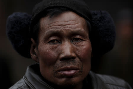 A worker watches a Chinese opera performance that Xinyuan Steel put on to mark the end of Chinese New Year festivities in Anyang, Henan province, China, February 19, 2019. REUTERS/Thomas Peter