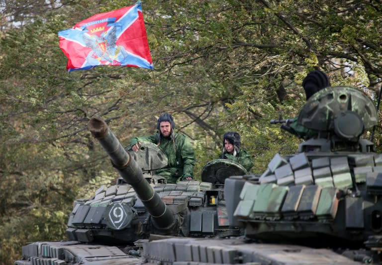 Pro-Russian separatists soldiers withdraw their tanks from a position near the town of Novoazovsk in the Donetsk region on October 21, 2015