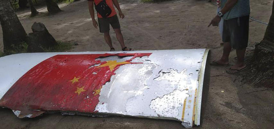 In this handout photo provided by the Philippine Coast Guard, Coast Guard personnel check on debris, which the Philippine Space Agency said has markings of the Long March 5B (CZ-5B) Chinese rocket that was launched on July 24, after it was found in waters off Mamburao, Occidental Mindoro province, Philippines on Aug. 2, 2022. In July, the core stage debris of the Long March 5B rocket that was launched in China landed in Philippine waters in an uncontrolled reentry, the agency said. No damage or injuries were reported. (Philippine Coast Guard via AP)