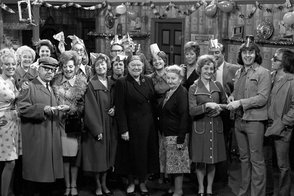 Coronation Street stars during a Christmas Party sequence at the Rovers Return. Left to right, Julie Goodyear as Bet Lynch; Doris Speed as Annie Walker; Jack Howarth as Albert Tatlock; Betty Driver as Betty Turpin (behind); Barbara Knox as Rita Littlewood; Anne Kirkbride as Deidre Hunt (behind), as Jean Alexander as Hilda Ogden; unidentified; Stephen Hancock as Ernest Bishop; as Geoffrey Hughes as Eddie Yeats (at the back); Violet Carson as Ena Sharples; Eileen Derbyshire as Emily Bishop; Margo Bryant as Minnie Caldwell; unidentified; Thelma Barlow as Mavis Riley; Bernard Youens as Stan Ogden; Neville Buswell as Ray Langdon; unidentified.   (Photo by PA Images via Getty Images)