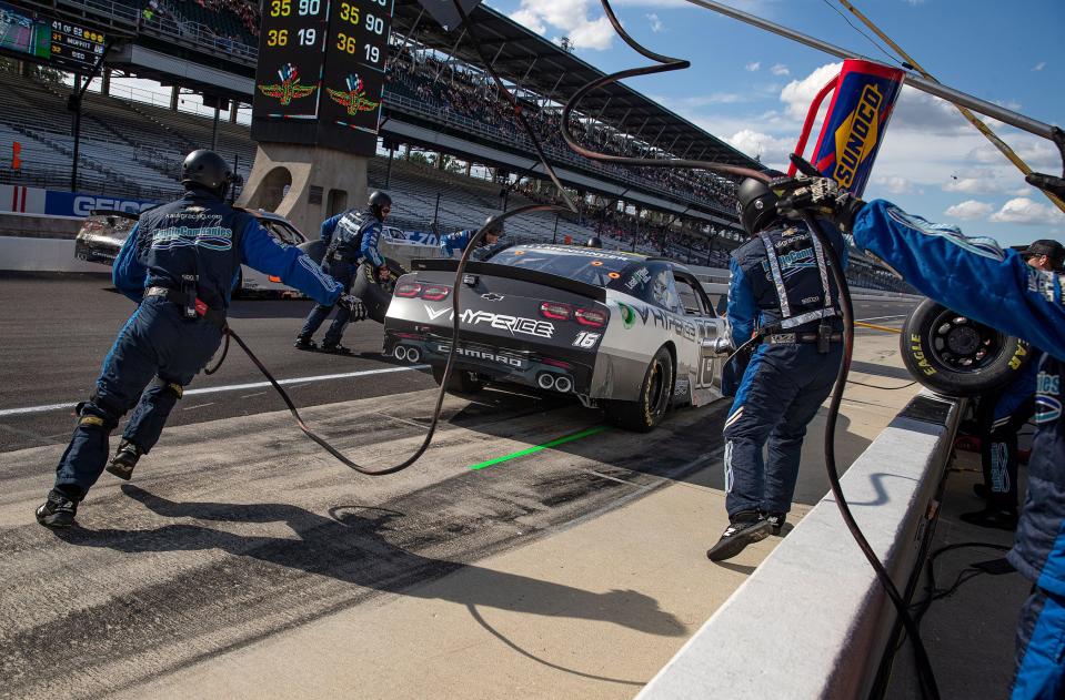 Crew members for AJ Allmendinger (16) complete a pit stop during the NASCAR Xfinity Series Pennzoil 150 on Saturday, Aug. 14, 2021, at Indianapolis Motor Speedway. 