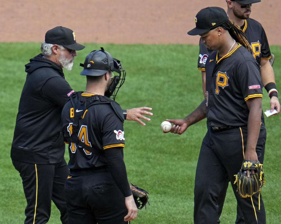 Pittsburgh Pirates starting pitcher Luis L. Ortiz, right, hands the ball to manager Derek Shelton, left, during the sixth inning of the first baseball game of a split doubleheader against the Washington Nationals in Pittsburgh, Saturday, Sept. 7, 2024. (AP Photo/Gene J. Puskar)