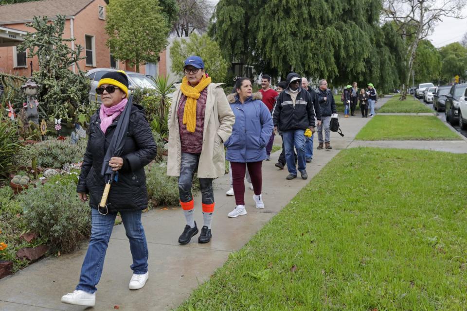 A group of housing insecure and homeless people and families and their supporters rally on Sheffield Avenue on Saturday morning to "reclaim" a vacant house that they say is owned by Caltrans.