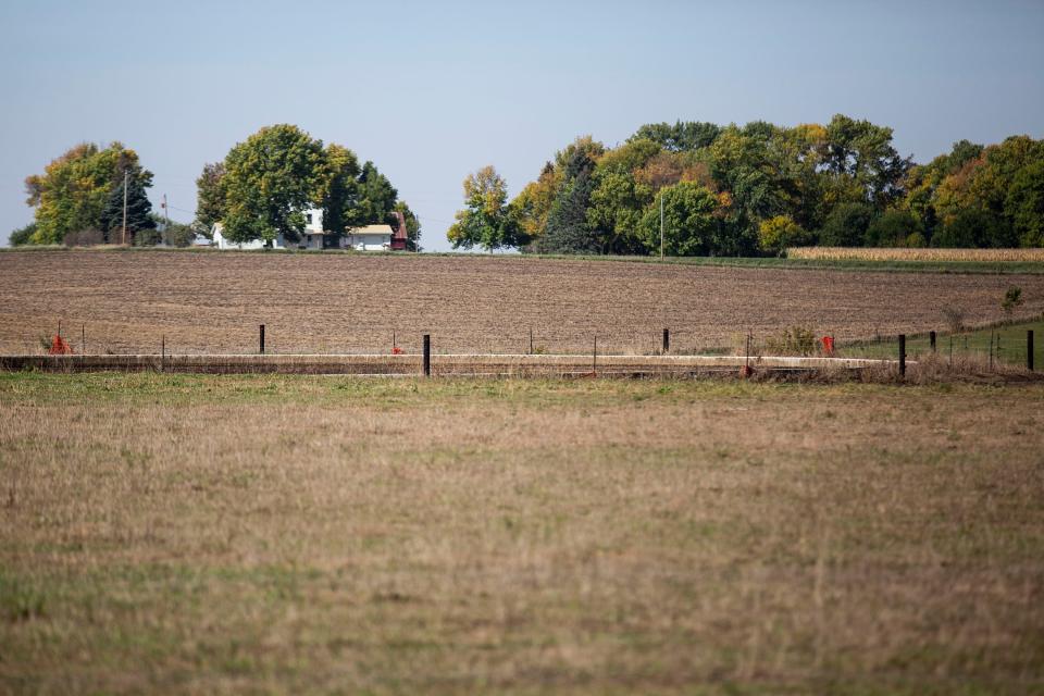 A large, open lagoon holding at least 300,000 gallons of byproducts from pork processing sits on this otherwise disused hog facility outside Algona. A man agitating the lagoon with an auger mounted to a tractor died after being overcome by the fumes in September 2021.