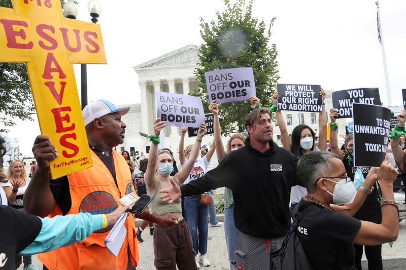 FILE PHOTO: People protest for and against abortion rights outside of the U.S. Supreme Court building in Washington